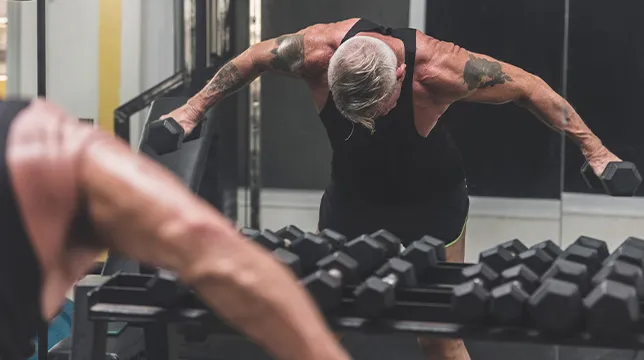 Man in gym with dumbbells